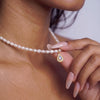 Model wearing gemstone drop pearl necklace, AllureNL